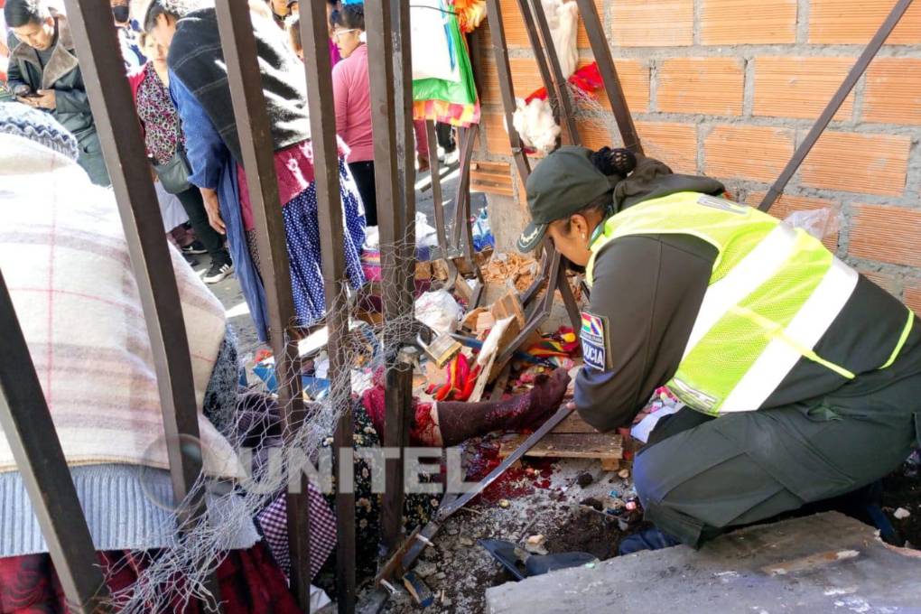 Una funcionaria de la Policía ayuda a la comerciante herida.