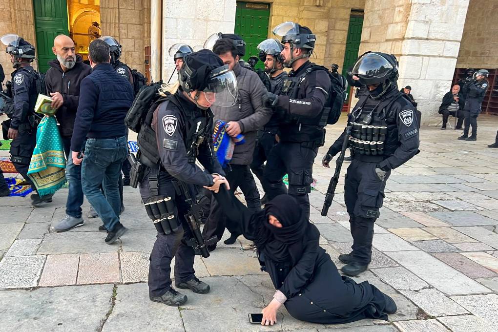 Las fuerzas de seguridad israelíes retiran a los fieles musulmanes palestinos sentados en los terrenos del recinto de la mezquita de Al-Aqsa en Jerusalén.