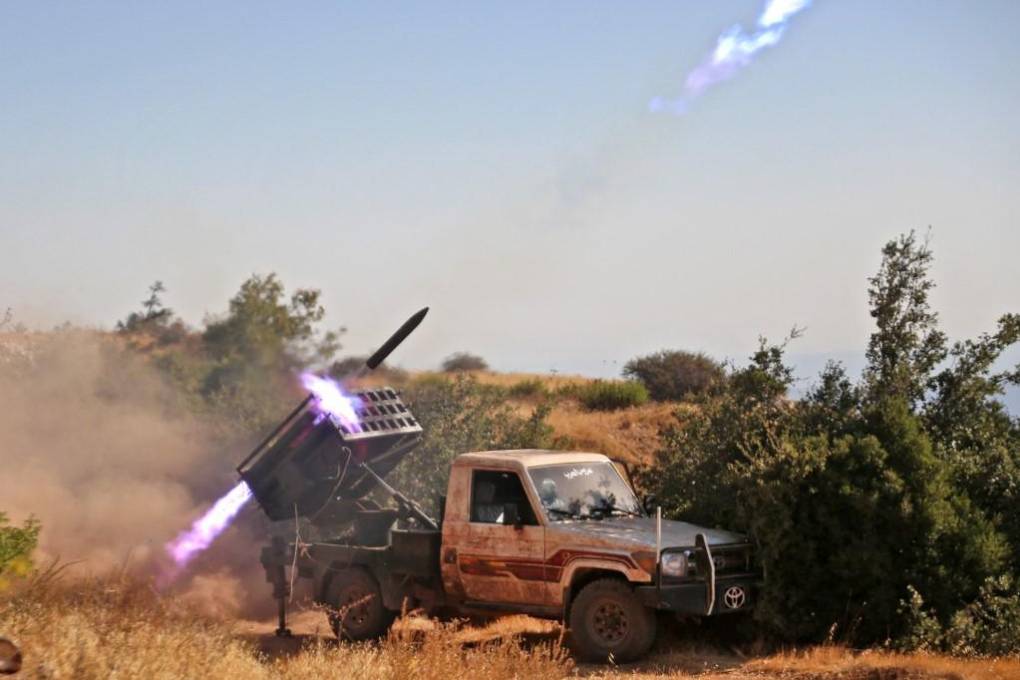 Syrian rebel fighters launch rockets from Jabal al-Turkman in the western countryside of the northwestern Latakia province, toward Syrian regime and Russian positions on September 9, 2022, in retaliation against Russian airstrikes a day earlier, on the rebel-held western countryside of Idlib. (Photo by aaref watad / AFP)